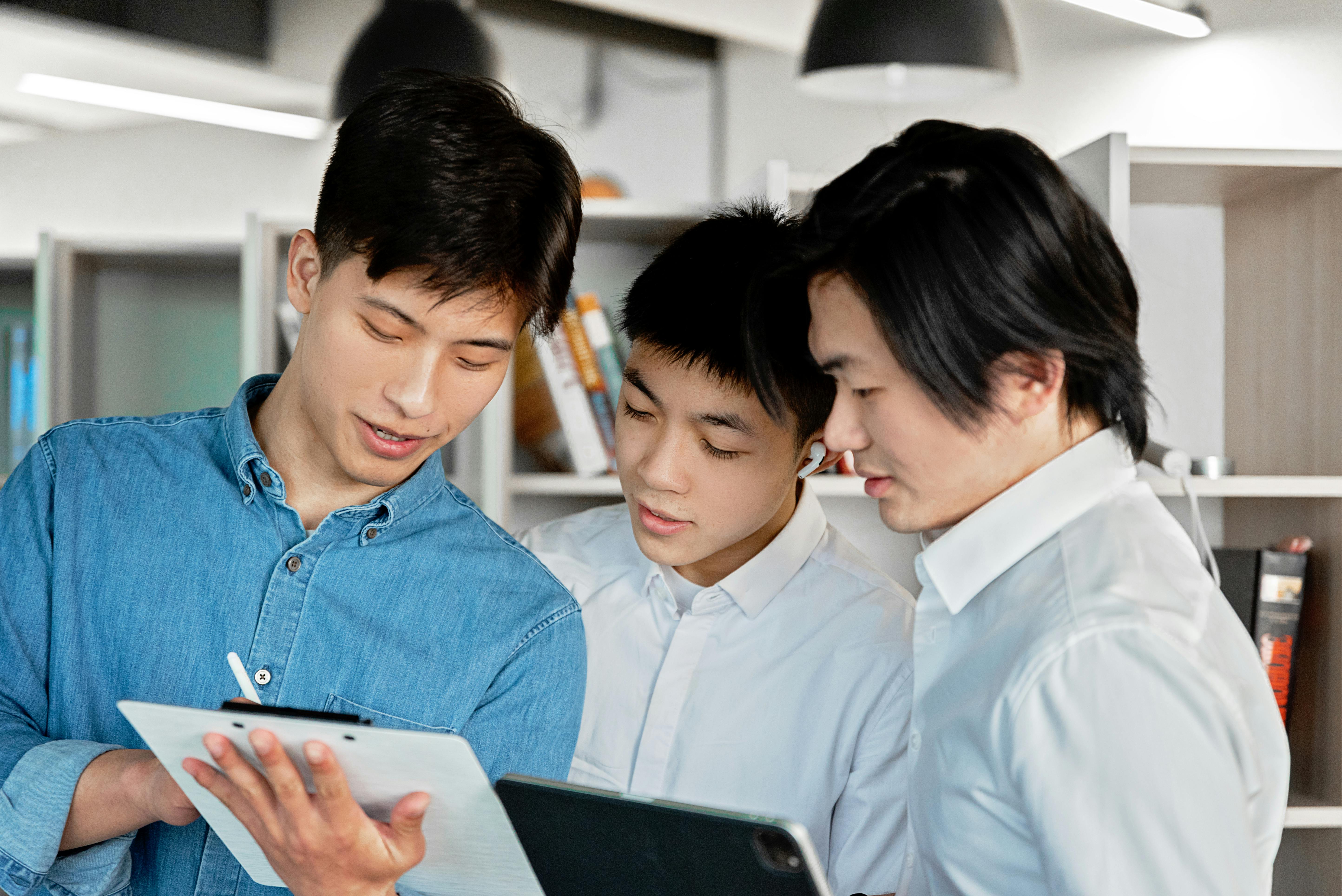 Colleagues collaborating at a laptop in a modern office. Photo: Mikhail Nilov / Pexels.