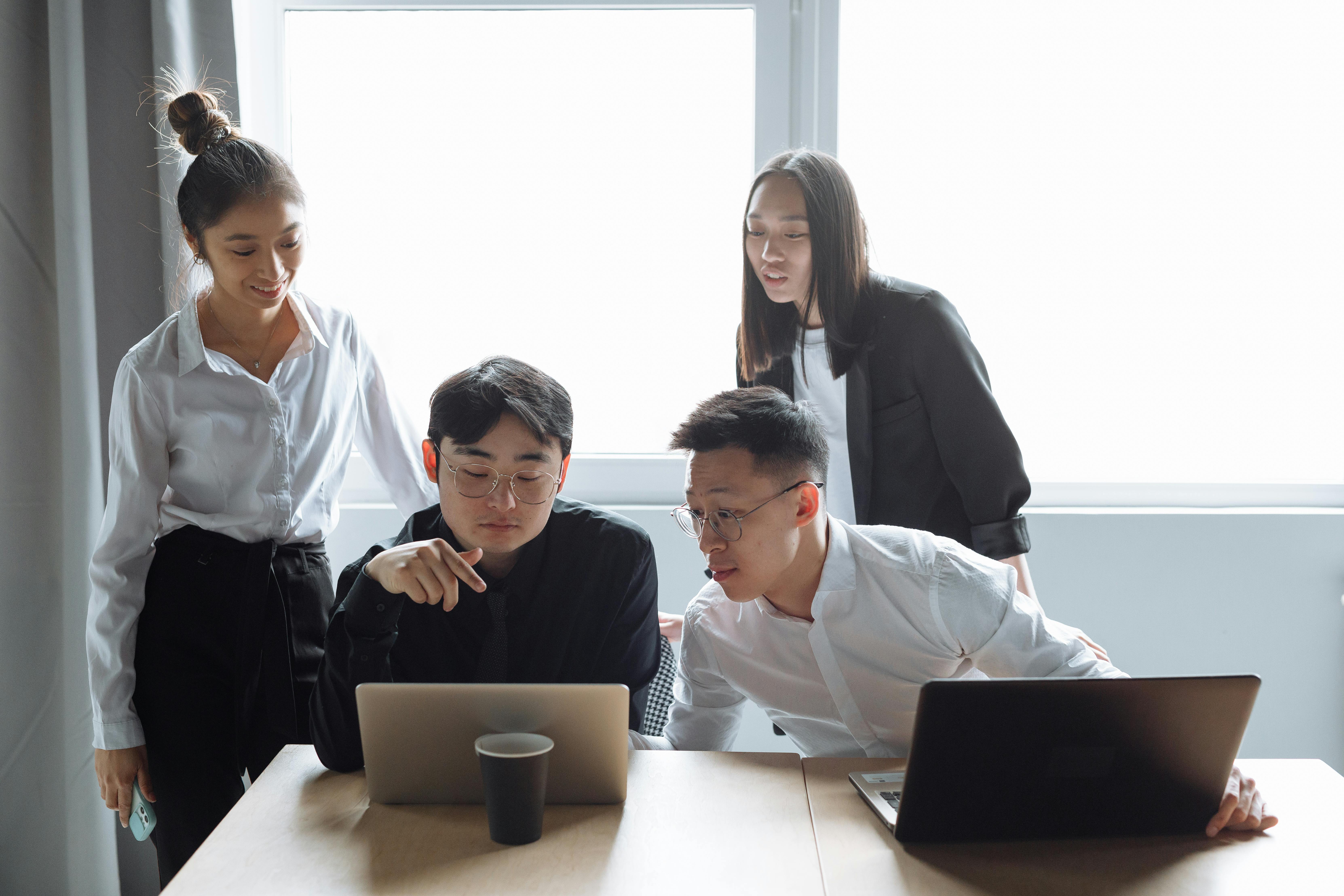 Professional handshake across a desk with documents, suggesting agreement or partnership. Photo: Thirdman / Pexels.