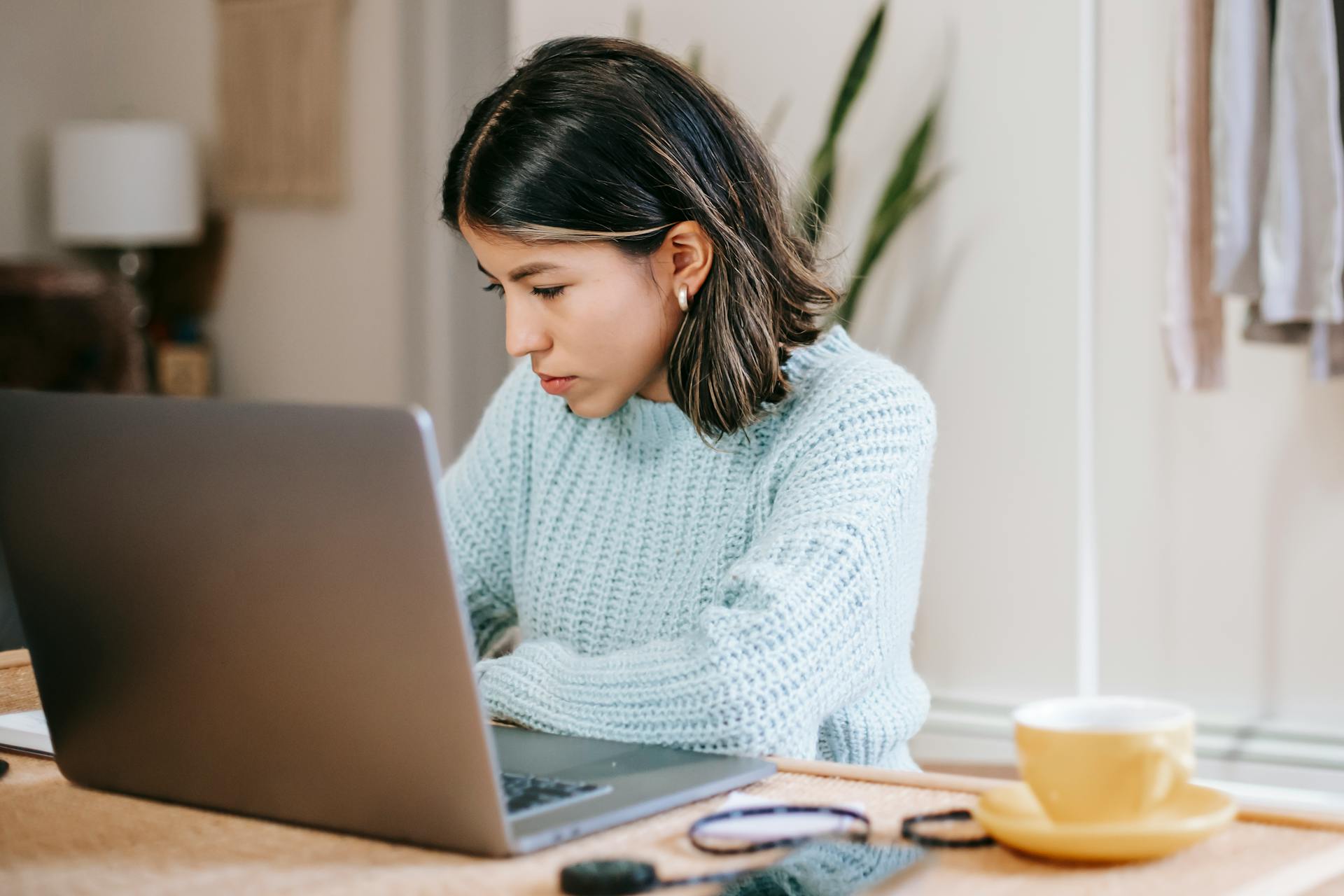 Learner focused on a laptop in a bright study or home setting. Photo: Liza Summer / Pexels.