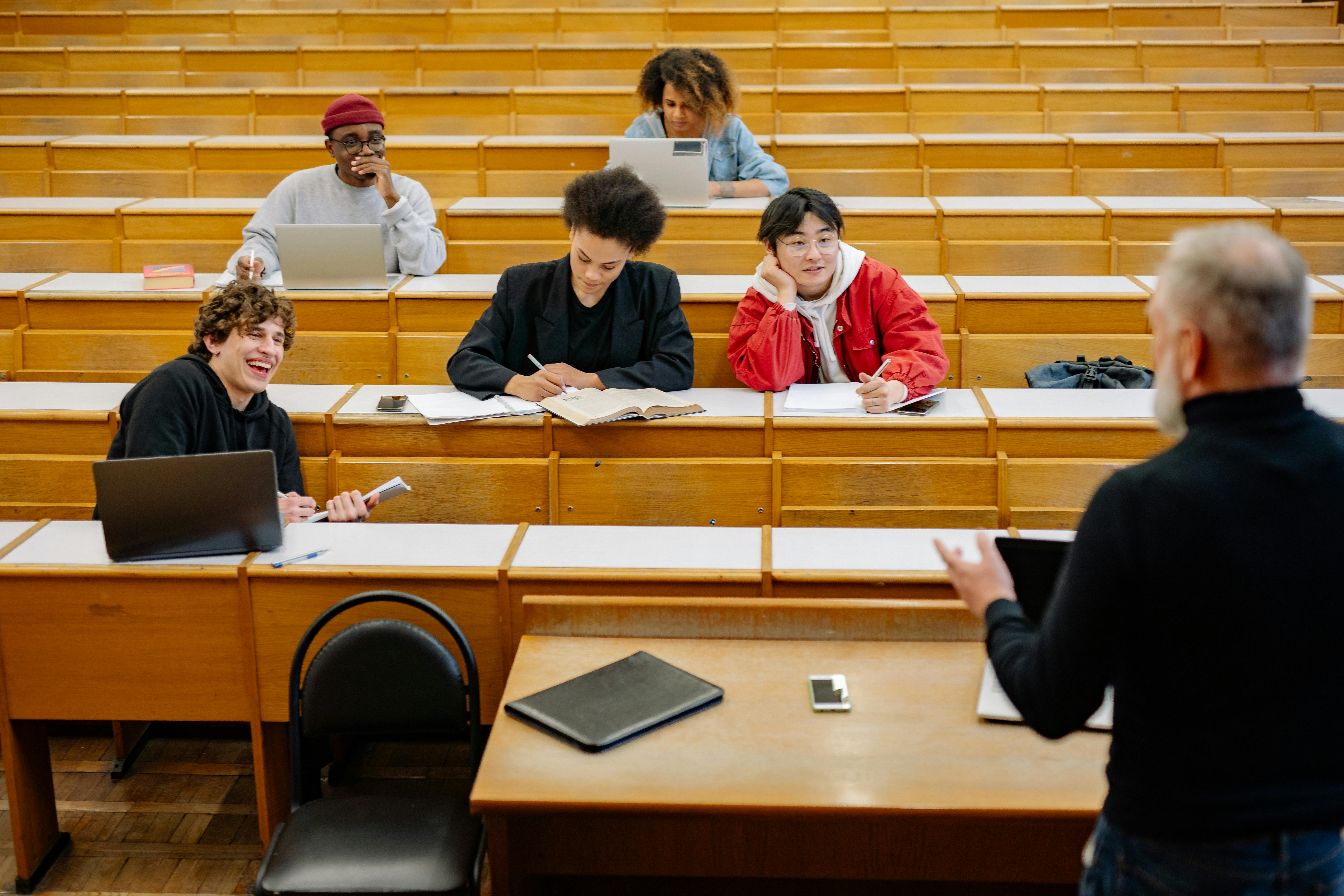 Colleagues reviewing paperwork and a laptop together at a conference table. Photo: Yan Krukau / Pexels.